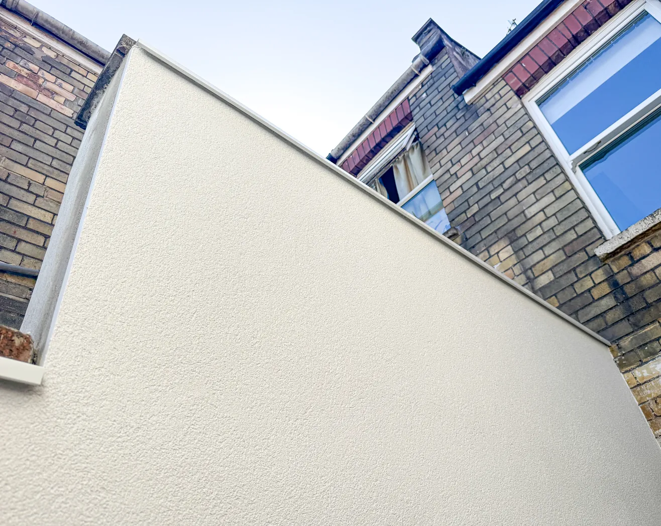 Self-cleaning, weatherproof silicone render finish on a shared party wall in Bedminster, Bristol