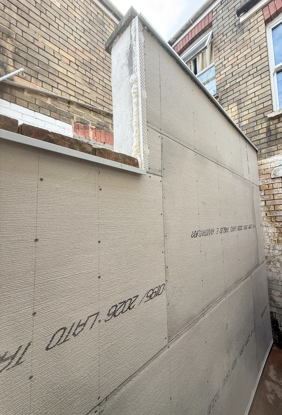 Treated timber battens and heavy-duty cement boards forming a ventilated isolation cavity on a damp brick wall in BS3 Bristol